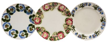 Seven Kuznetsov pottery chargers each stencilled and sprayed with flowers and fruit, 34cm diameter,