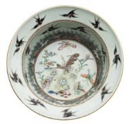 A Chinese porcelain basin the interior enamelled with butterflies and flowers