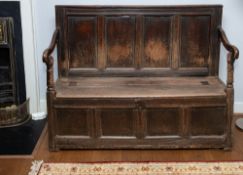 A panelled oak box settle,