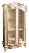 A white painted wood and wirework bow fronted cabinet in Louis XV taste,