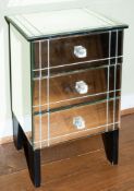 A mirrored glass bedside chest of three drawers,