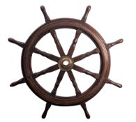 A teak and brass ship's helm,