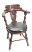An Edwardian oak ship's tub chair,