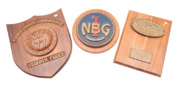 A brass ward room badge for the United Stares Naval Beach Group-1, on a wooden base, 25cm diameter,