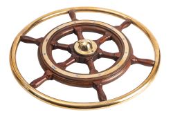A teak and brass helm with block and turned spars,
