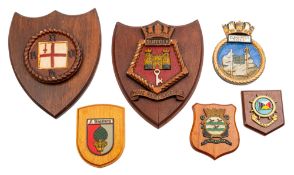 An alloy ship's badge for HMS 'Suffolk' on a mahogany shield plinth,