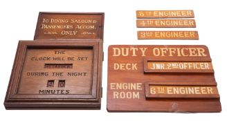 A wooden passenger ship notice 'Duty Deck Officer' with sliding panels for changing 'Deck'