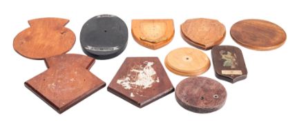 Ten various wooden ship's badge plinths,