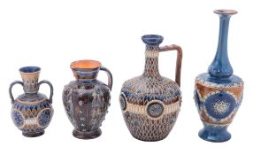 Two Doulton Lambeth stoneware ewers and a vase with incised and embossed decoration under blue,
