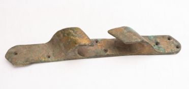 A salvaged bronze fairlead, reputedly from a shipwreck off Swanage, 62cm long.