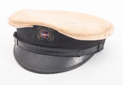 An early 20th century New York Yacht Club peaked cap, circa 1920s/30s, white cap with black band,