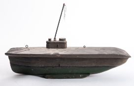 A scratch built wooden model of an aircraft carrier with mast over bridge and plain flight deck,