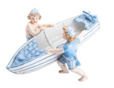 An Austrian porcelain figure group of two children launching a boat, under glaze 'R' mark,