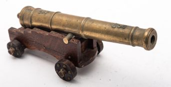 An 8 inch brass model of a cannon, teh five stage barrel with crown and 'L' initial to top,