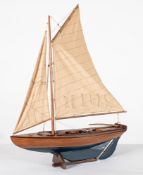 A scale model of a sailing dingy, fully rigged over plank and pinned hull with fittings,