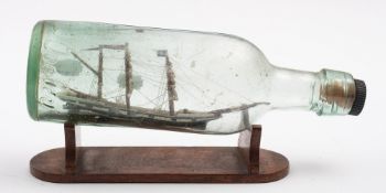 A late 19th /early 20th century ship in a bottle of the clipper 'Lizzie' standing rigged over