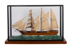 A cased waterline scale model of a three masted schooner.
