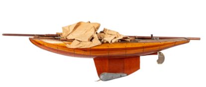 An early 20th century pond yacht, rigged over one piece deck,
