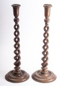 A pair of mahogany candlesticks constructed from timber taken from HMS' Britannia,