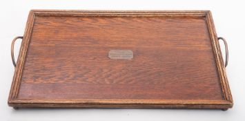 An early 20th century WWI period rectangular oak tray with brass plaque inscribed 'From Surrendered