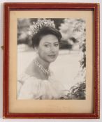A Signed photo of Princess Margaret. Dated 1976 and in a red gilt tooled frame, 28cm, 23cm.