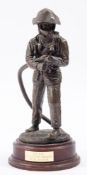 A 20th Century cast resin figure of a firefighter, maker Ballantynes of Walkerburn.