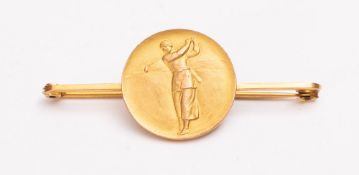 A 9ct gold golf related stick pin, obverse with an image of a female golfer at top swing,