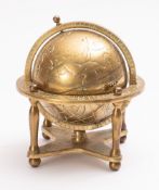 A 20th Century brass desk ornament in the form of a globe.