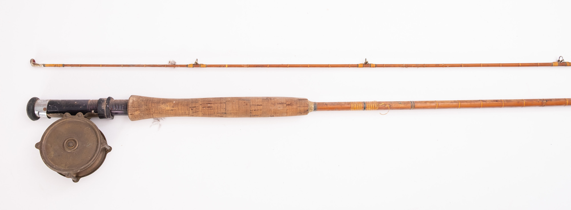 An early 20th Century two piece fly fishing rod fitted with a 3' brass reel.