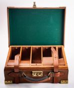 A 20th Century brown leather and brass cartridge case. Having a fitted interior and leather handle.
