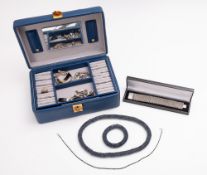 A small collection of silver and costume jewellery in a leather bound jewellery box.