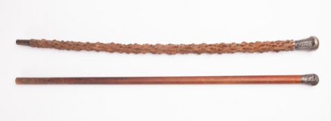 A Chinese whitemetal mounted walking stick, the pommel with floral decoration on a rootwood shaft,