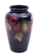 A Walter Moorcroft pottery vase of oviform tube lined in the Anemone pattern reserved on a blue