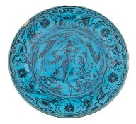 A Safavid stonepaste Kubachi Ware dish painted in black with fish,