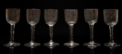 A part suite of gilt decorated drinking glasses comprising sixteen goblets with ogee bowls
