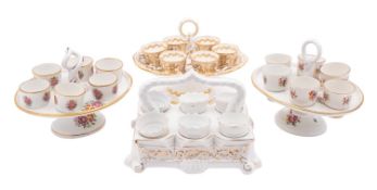 A group of three English porcelain egg cup stands and egg cups,