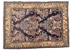 A Qum Rug, the indigo field with a design of floral foliate sprays and stylised animals,