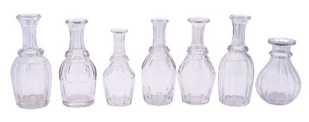 Seven heavy cut glass water bottles of various sizes and forms, tallest 21cm high,