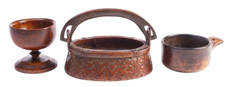 A carved and stained treen hand basket, 19th century; of oval form,