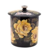 A Wemyss pottery biscuit barrel and cover painted by Edwin Sandland with yellow cabbage roses on a