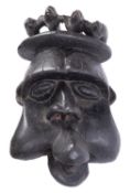 A large African carved and stained wood tribal mask, probably Cameroon Bamum, 53cm.