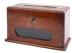 An Edwardian house letter box in oak with glass 'window' and brass aperture inscribed 'Letters',