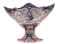 An Imari porcelain pedestal dish of pierced boat shaped form, 28cm long, Meiji.