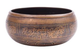 A Tibetan inlaid bronze bowl the interior cast with figures of Buddha around a central rosette,