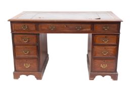 A hardwood and leather inset pedestal desk in George III style, ca1900.