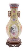 A Chinese porcelain vase of hexagonal profile with 'cash' handles enamelled front and verso with