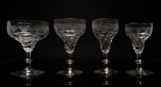A part suite of drinking glasses with faceted ogee bowls engraved with fruiting vine