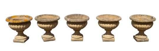 A set of five reconstituted stone garden urns, modern; with egg-and-dart moulded everted rims,