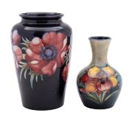 Two Walter Moorcroft pottery vases the first of shouldered cylinder form tube lined in the Anemone