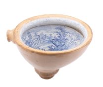 A pottery toilet bowl or water closet the interior transfer decorated in blue with a version of the